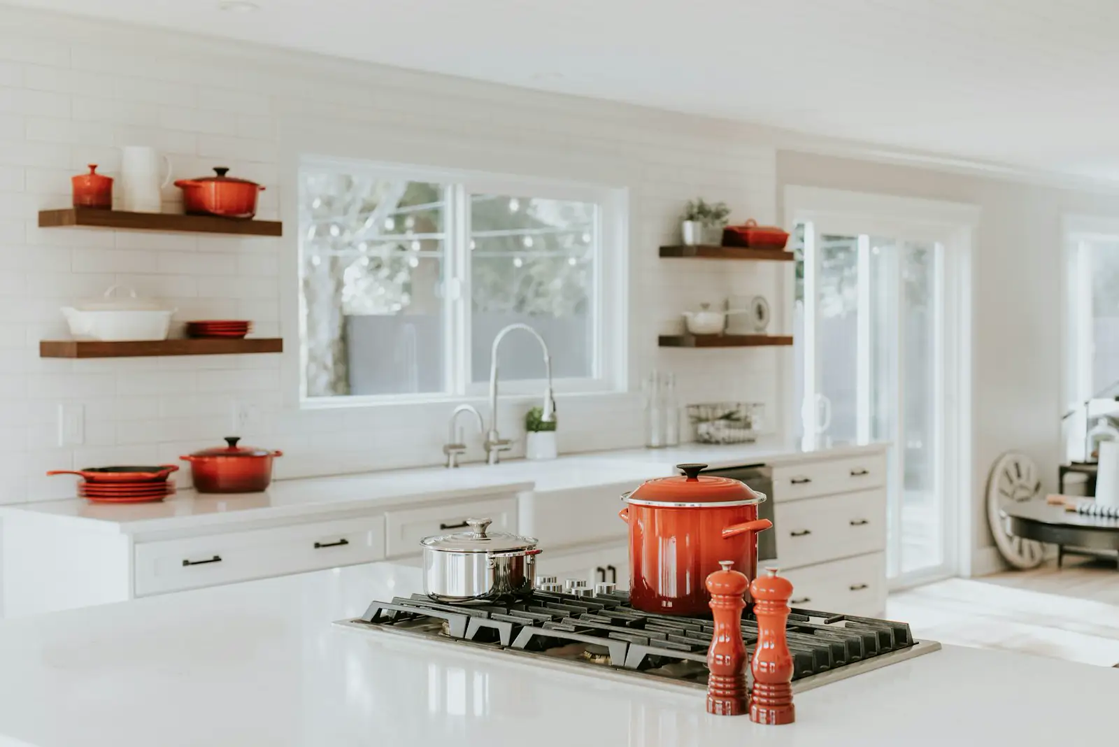 A white kitchen with a gas cooktop set into the island. Shown on the homepage for St. Petersburg, FL.